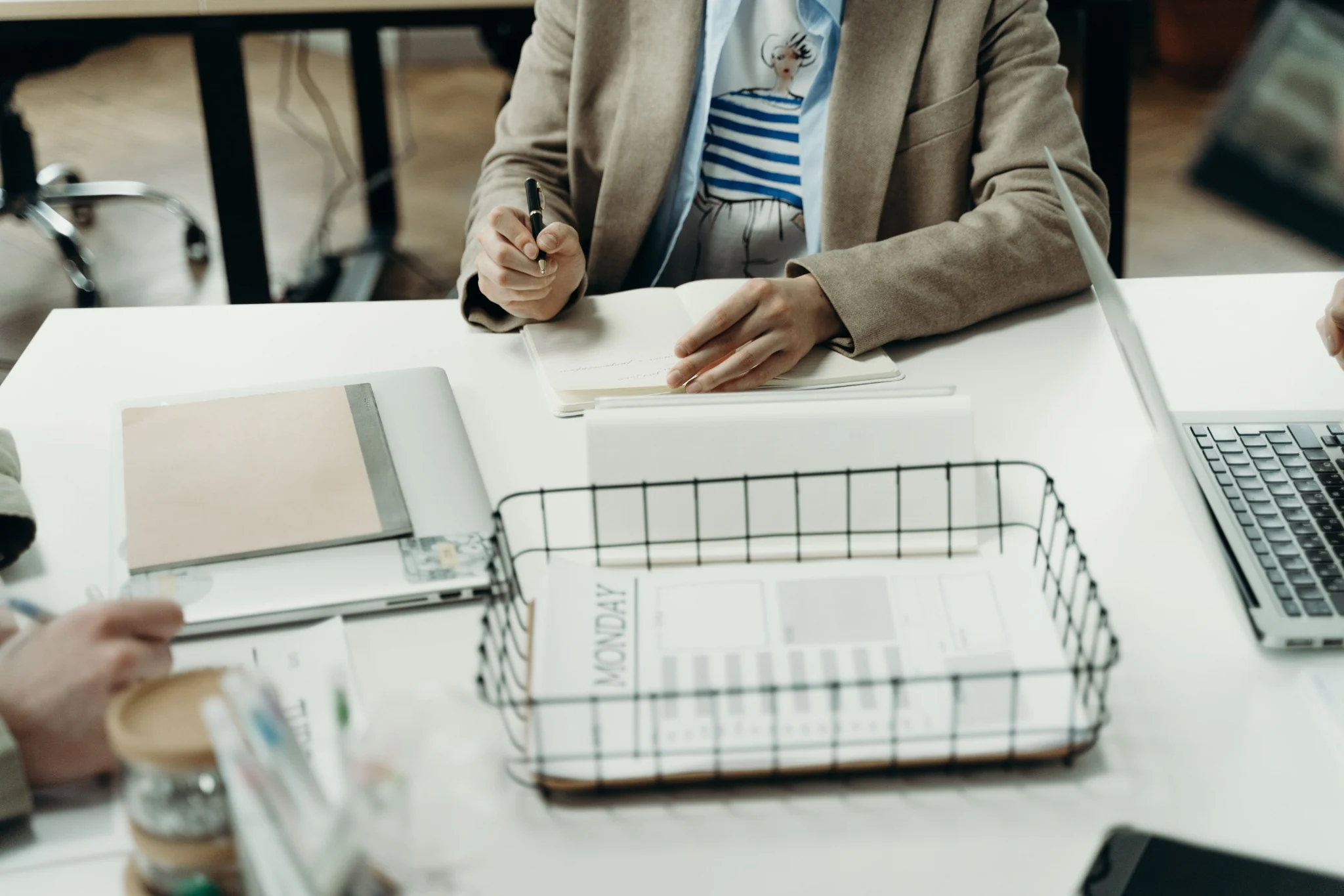 Two people reviewing notes together at a worktable.