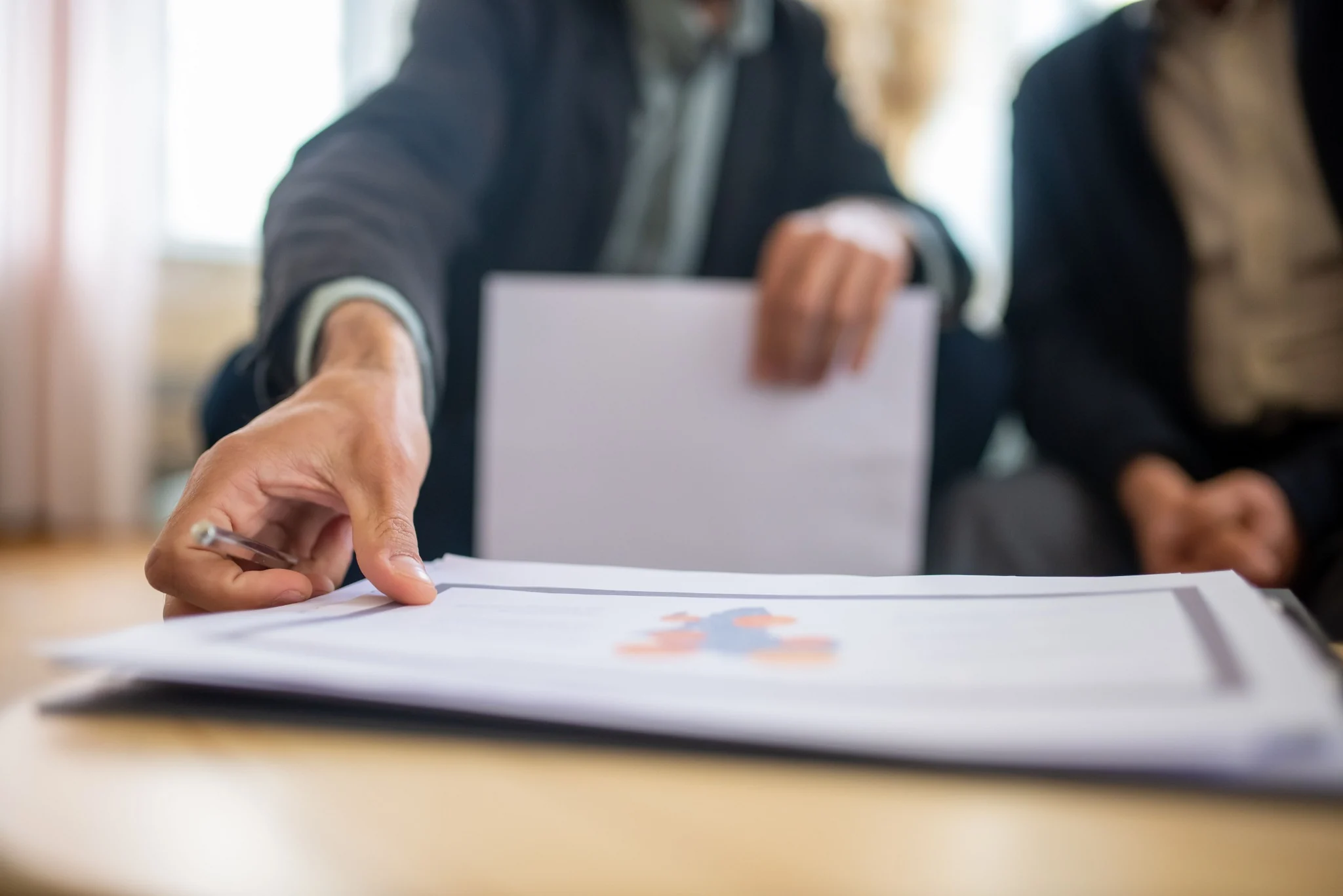 People reviewing a printed report together during a working session.